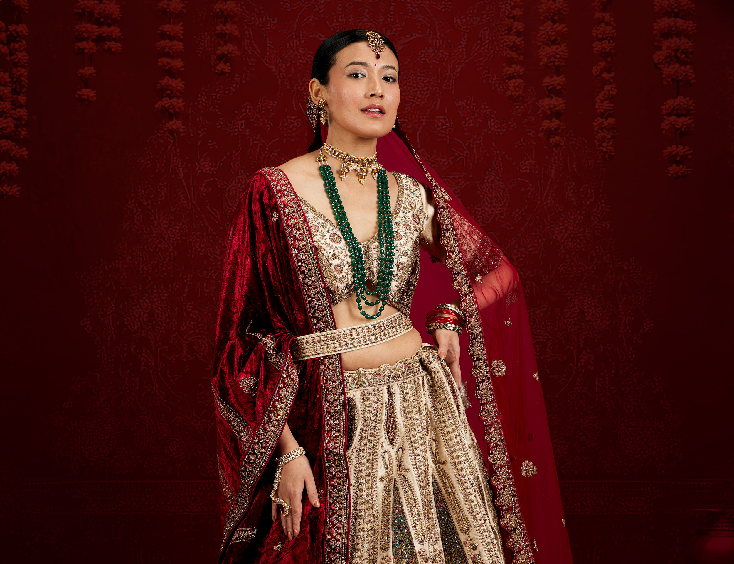 Elegant red lehenga and blouse set styled for a bridal outfit